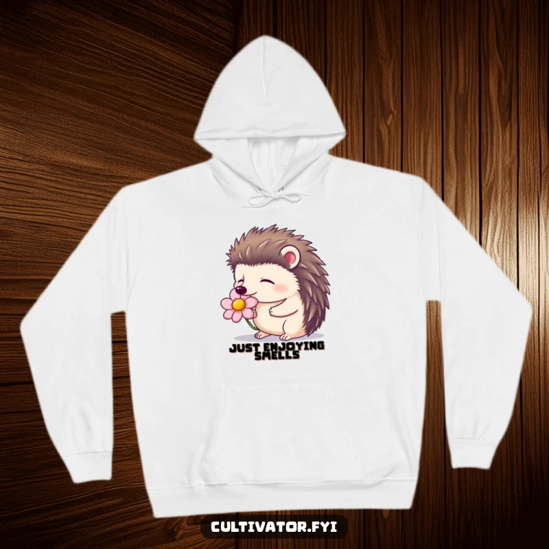 Funny hoodie featuring a contented hedgehog with closed eyes, smelling a blooming flower, offering cozy relaxation.
