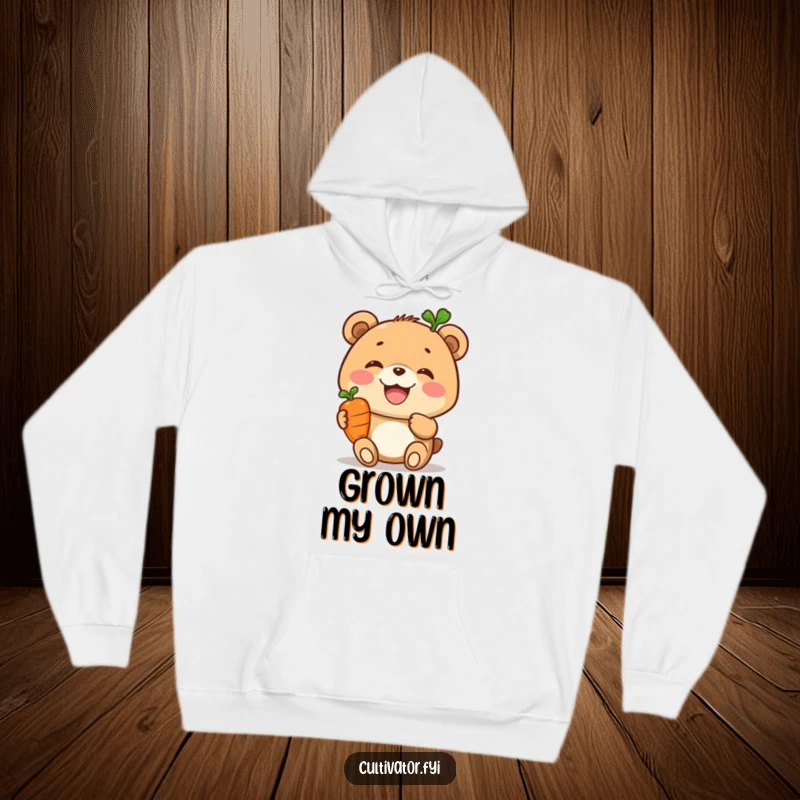 Funny hoodie, joyful bear balancing a carrot on its head, cozy and warm, healthy animal design, humorous apparel.