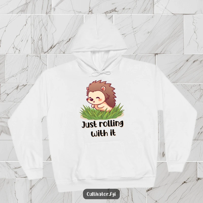 Funny Hedgehog Hoodie: Giggling hedgehog character rolls through soft green grass, warm and playful.