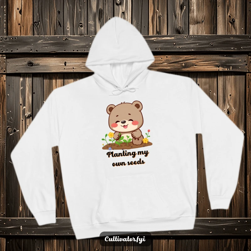Funny bear hoodie illustrating a bear joyfully giggling while planting seeds with serious determination, ready for outdoor tasks.